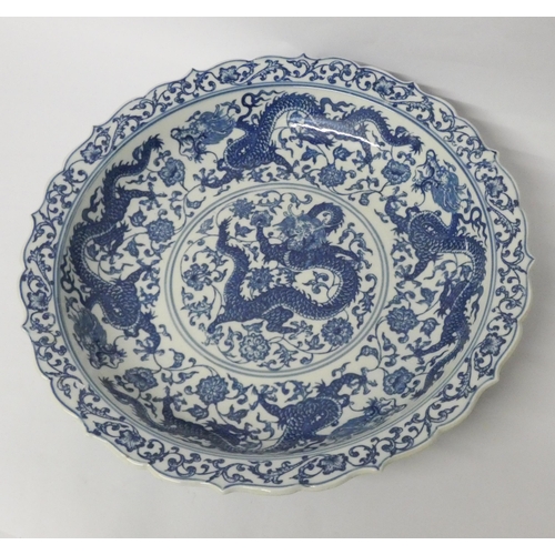 266 - A Chinese blue and white dish decorated with dragons chasing pearls, character mark to base, diamete... 