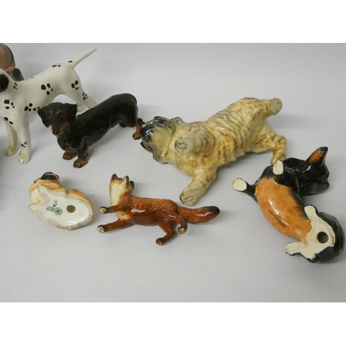 285 - A collection of Beswick, Doulton and Wedgwood figurines, mostly of dogs but with a fox, a donkey foa... 