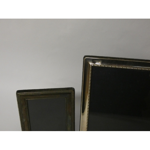 638 - Two modern silver rectangular photo frames, the largest is 23cms tall