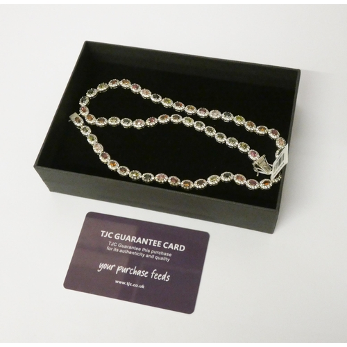 455 - A rainbow Tourmaline cluster necklace in platinum plated sterling silver, unworn with tag and certif... 