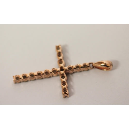 485 - A champagne diamond cross pendant set in 9ct rose gold, 34mm long.