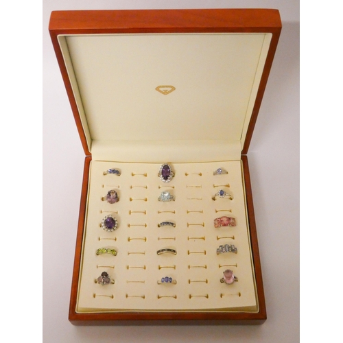 491 - A collection of 15 silver and gemstone set dress ring in a fitted box