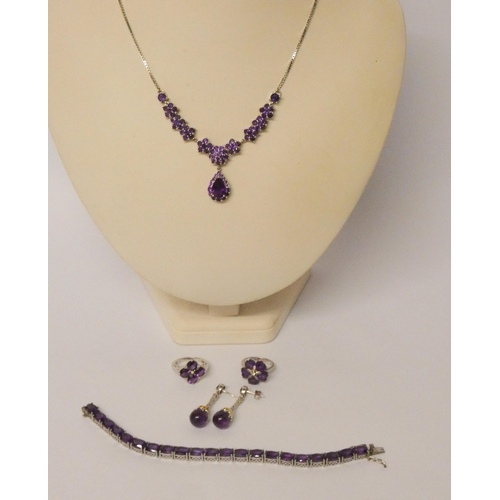 492 - A collection of silver jewellery - all  set with 'amethyst' style stones.