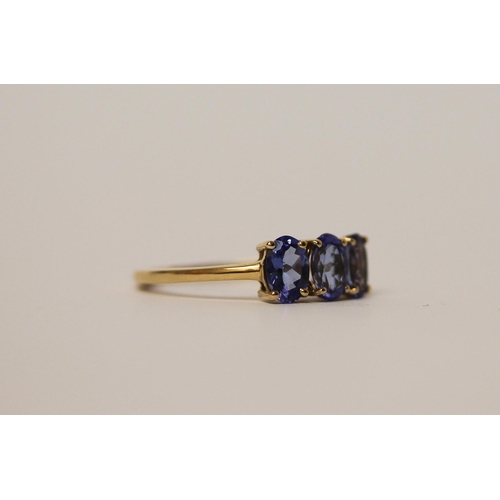 496 - 14ct gold three stone tanzanite dress ring, ring size L