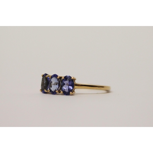 496 - 14ct gold three stone tanzanite dress ring, ring size L