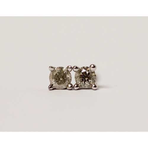 497 - A pair of diamond ear studs, claw set on 9ct white gold posts, diamond weight 0.25 carats each, with... 