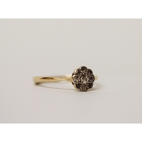 507 - Edwardian 18ct gold and platinum mounted diamond flower head design ring. Ring size J, 1.8g