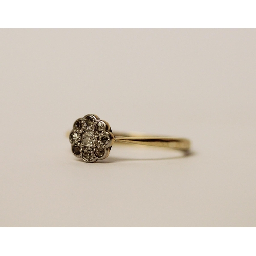 507 - Edwardian 18ct gold and platinum mounted diamond flower head design ring. Ring size J, 1.8g