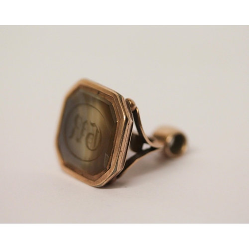 519 - An intaglio panel fob seal, the hardstone carved with initials GR, in rose coloured metal, unmarked.