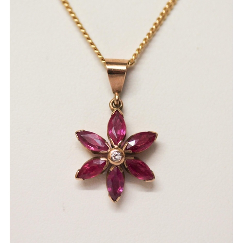 533 - A ruby and diamond flower head pendant on 9ct gold chain.6.5 grams gross weight