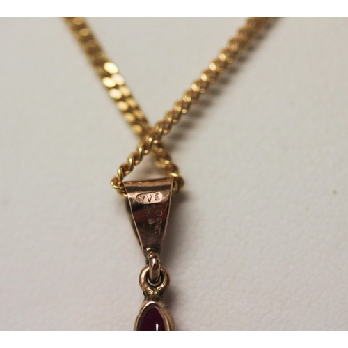 533 - A ruby and diamond flower head pendant on 9ct gold chain.6.5 grams gross weight