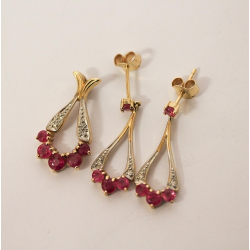 534 - A modern ruby and diamond pendant and drop earring set, in 9ct yellow gold