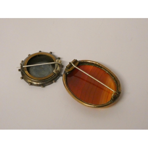 543 - A 19th century oval banded agate brooch and an Aesthetic movement gold and silver circular brooch