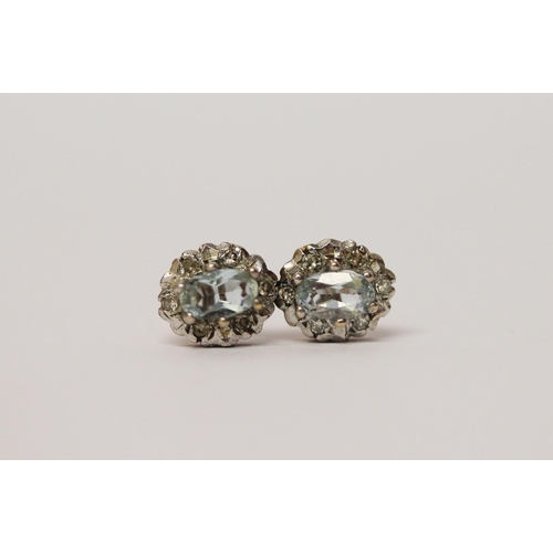 545 - A pair of modern aquamarine and diamond circular cluster stud earrings. 9ct gold posts