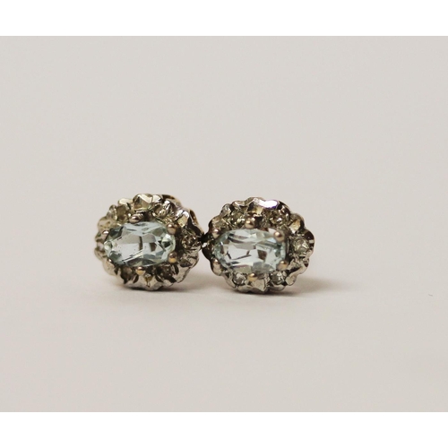 545 - A pair of modern aquamarine and diamond circular cluster stud earrings. 9ct gold posts