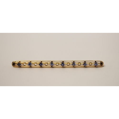 546 - A sapphire set bar brooch, of elongated oval form, hallmarked 14k. Gross weight 4.2g