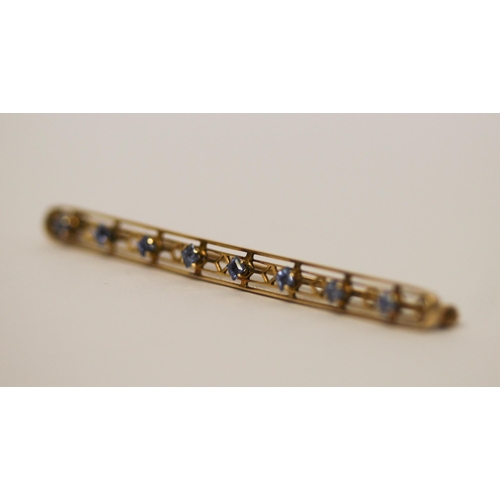 546 - A sapphire set bar brooch, of elongated oval form, hallmarked 14k. Gross weight 4.2g