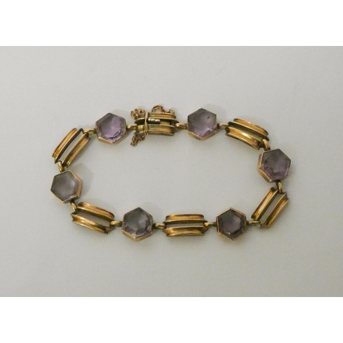 551 - An Art Deco amethyst bracelet, set with six hexagonal collet set amethysts on rose gold bar link cha... 