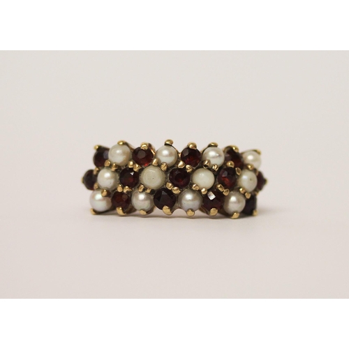 562 - A large garnet and pearl cluster ring designed as a wide band, 9ct gold, marks worn, Size M, weight ... 