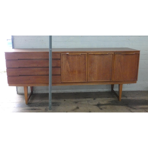 1 - A 1960's long low teak sideboard, fitted cupboards, four drawers and a drop down flap, 6' wide