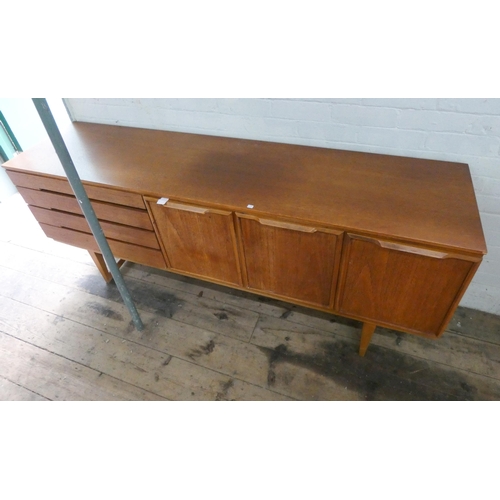 1 - A 1960's long low teak sideboard, fitted cupboards, four drawers and a drop down flap, 6' wide