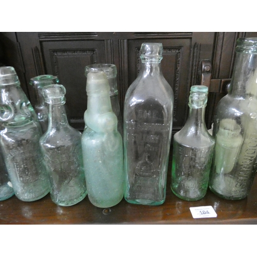 33 - A collection of old glass bottles to include 'Bushmills, Whisky', 'Sharwood & Co', 'South West Miner... 