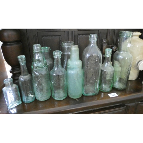 33 - A collection of old glass bottles to include 'Bushmills, Whisky', 'Sharwood & Co', 'South West Miner... 