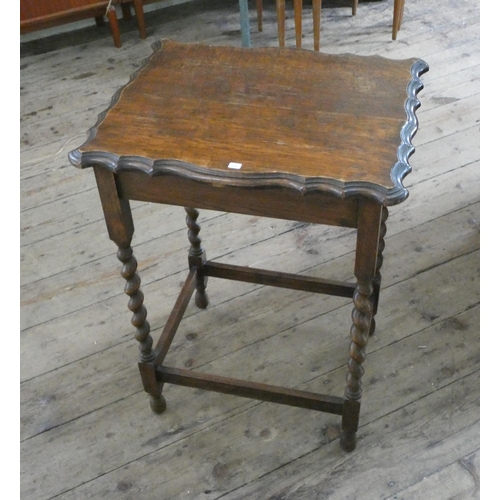 62 - An oak pie crust edge occasional table on barley twist legs