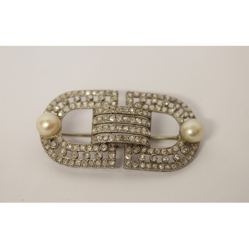 582 - An Art Deco diamond and pearl brooch by Marzo Paris, signed, circa 1920, pave set with diamonds with... 