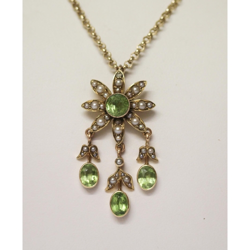 585 - An Edwardian peridot and seed pearl pendant, of floral design with three droppers, on a 9ct gold bel... 