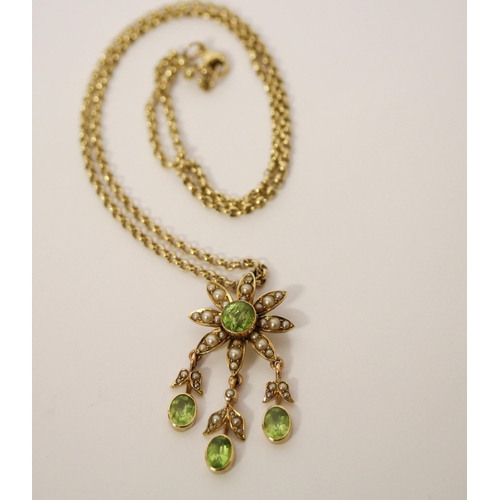 585 - An Edwardian peridot and seed pearl pendant, of floral design with three droppers, on a 9ct gold bel... 