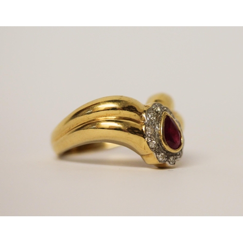 594 - A ruby and diamond ring, the tear drop4.8g ruby and diamond cluster mounted on a wide wishbone setti... 