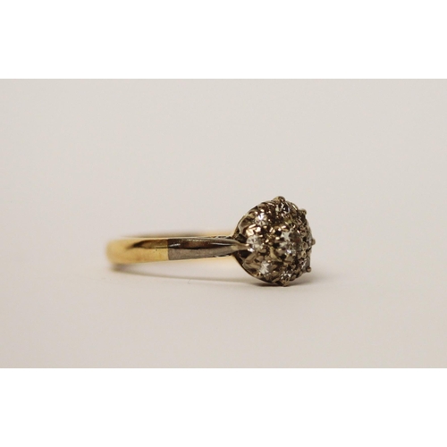 597 - A vintage diamond cluster ring, on 18ct gold band, ring size J, gross weight 2.6g