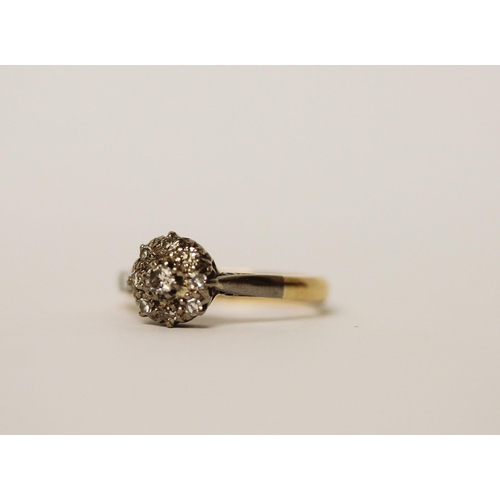 597 - A vintage diamond cluster ring, on 18ct gold band, ring size J, gross weight 2.6g