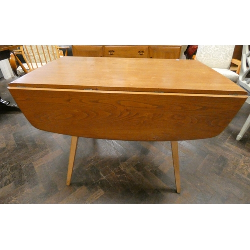 161 - An Ercol blonde elm drop leaf oval dining table