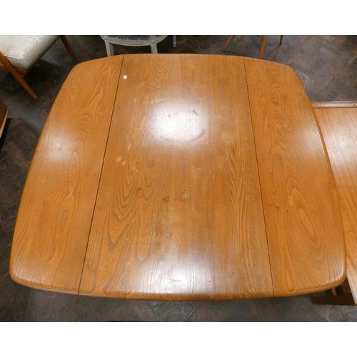 161 - An Ercol blonde elm drop leaf oval dining table