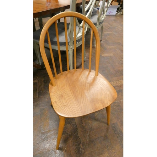 162 - An Ercol hoop stick back elbow chair and a matching dining chair