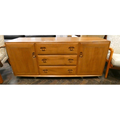 163 - An Ercol blonde elm sideboard fitted three central drawers with cupboards either end, raised on cast... 