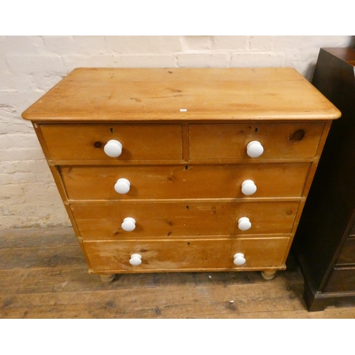 179 - An antique stripped and waxed pine chest of two short and three long drawers with white ceramic hand... 