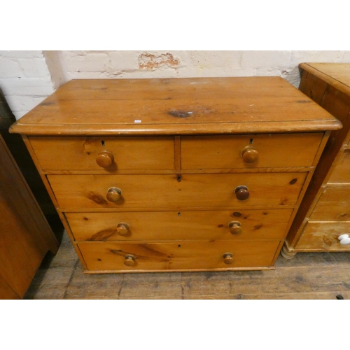 180 - A Victorian stripped and waxed pine chest of two short and three long drawers with bun handles