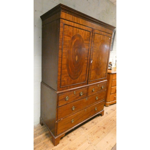 185 - A Georgian mahogany linen press, two shell inlaid cupboard doors with sliders within on a two short ... 