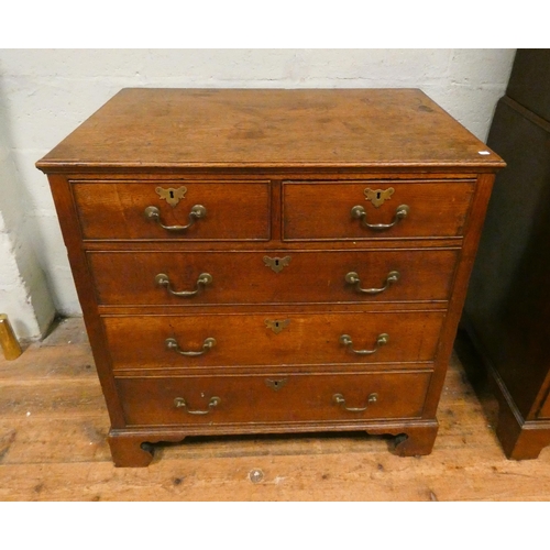 186 - An antique oak chest of two short and three long drawers with brass handles to bracket feet