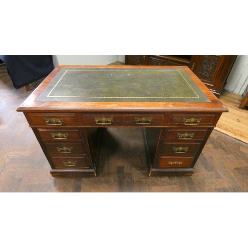 192 - An Edwardian walnut twin pedestal desk with inset green leather to the top