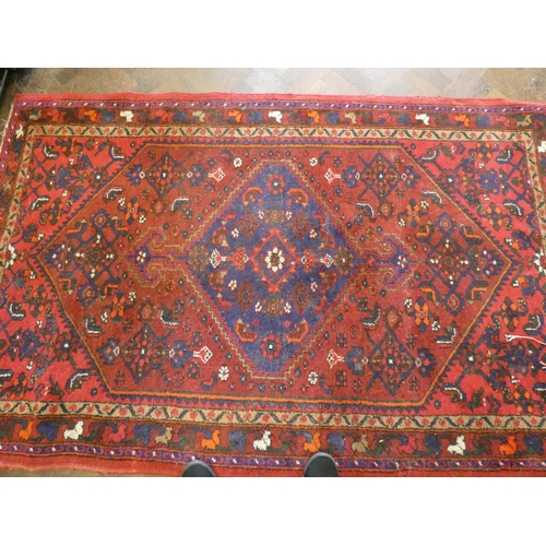 195 - A red figured Persian rug