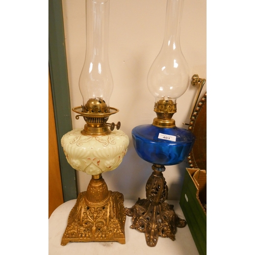 401 - Two Victorian oil lamps on painted gilt wrought iron bases