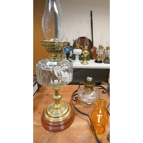 404 - An ornate Victorian oil lamp with clear glass reservoir and brass base together with a hanging oil l... 