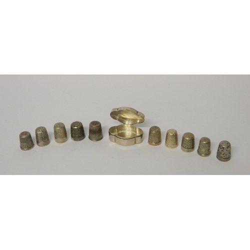 641 - A hallmarked silver quatrefoil pill box and a collection of thimbles - six of which are hallmarked s... 