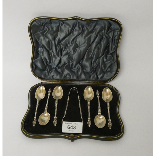 643 - A set of six silver apostle ended teaspoons and matching sugar tongs in fitted case.