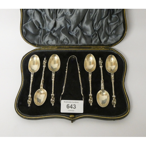 643 - A set of six silver apostle ended teaspoons and matching sugar tongs in fitted case.