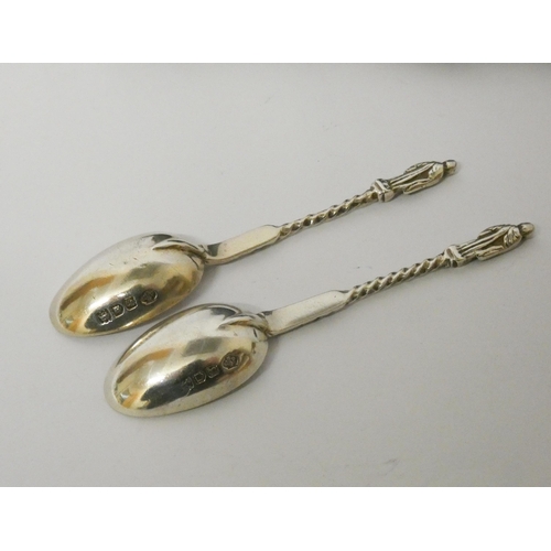 643 - A set of six silver apostle ended teaspoons and matching sugar tongs in fitted case.